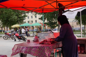 Traditional Muslim woman makes BBQ in Keketuohi Town